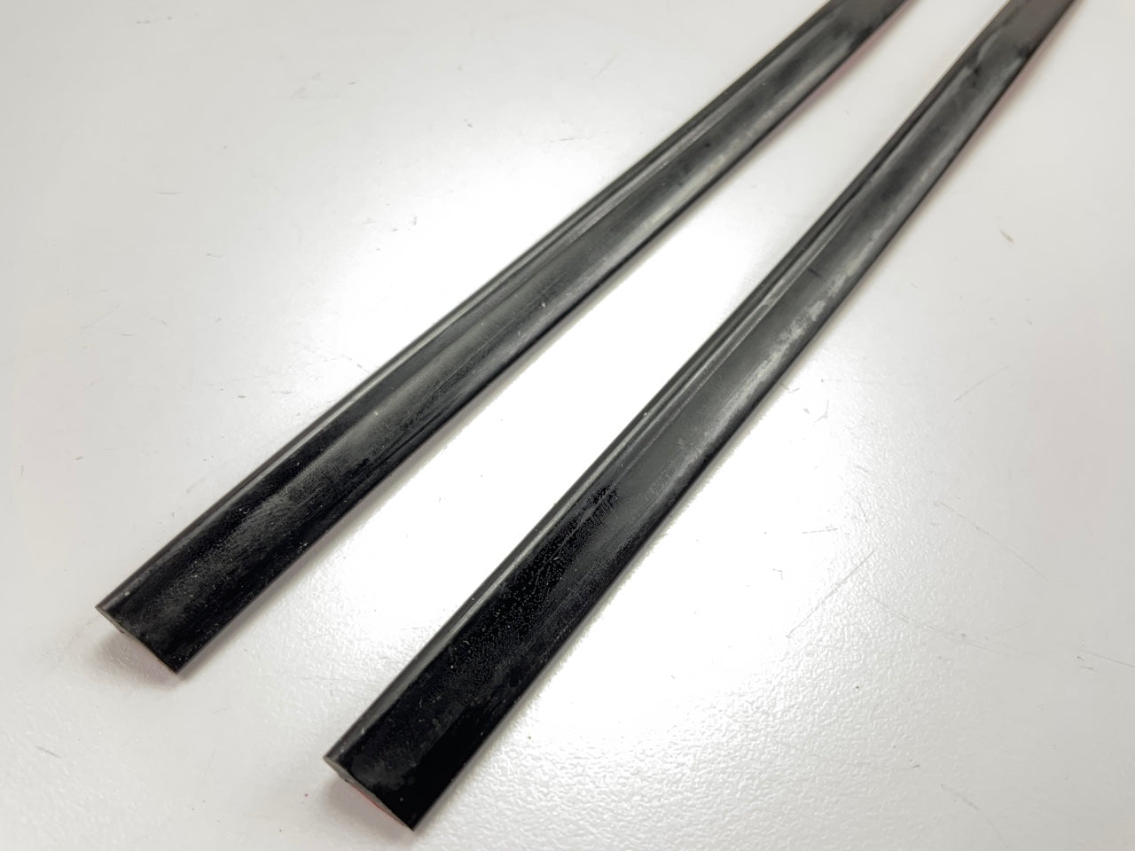 COWLES T4002 Black 3/8'' Wide Stick-On Door Edge Protection Trim Strips, 27'' Long