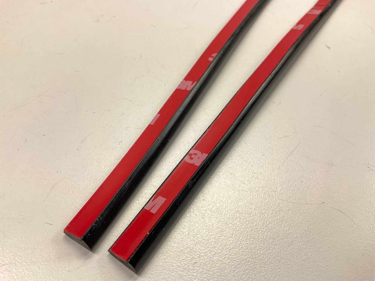 COWLES T4002 Black 3/8'' Wide Stick-On Door Edge Protection Trim Strips, 27'' Long