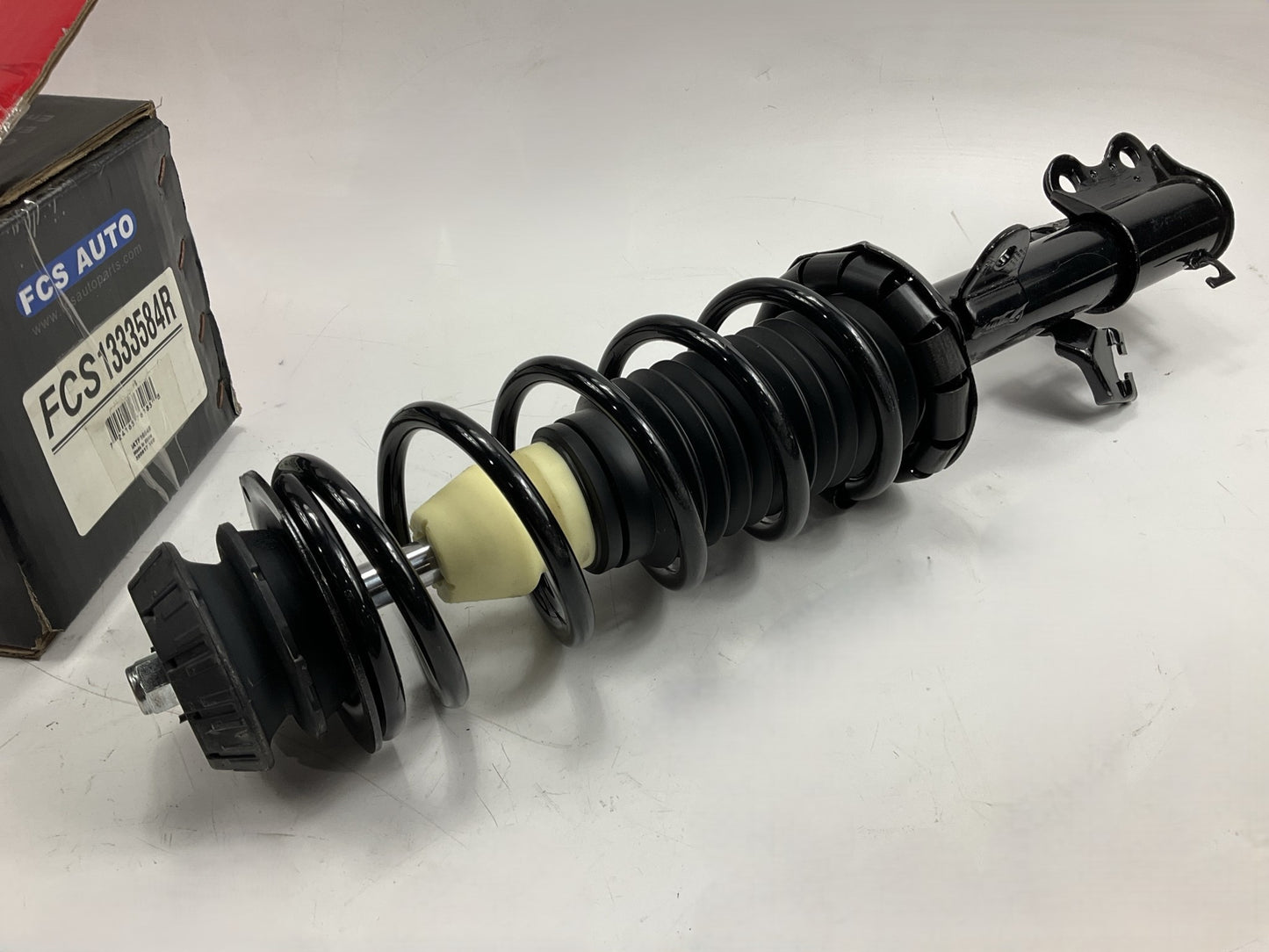 FCS 1333584R Front Right Strut With Coil Spring For 2012-2019 Nissan Versa