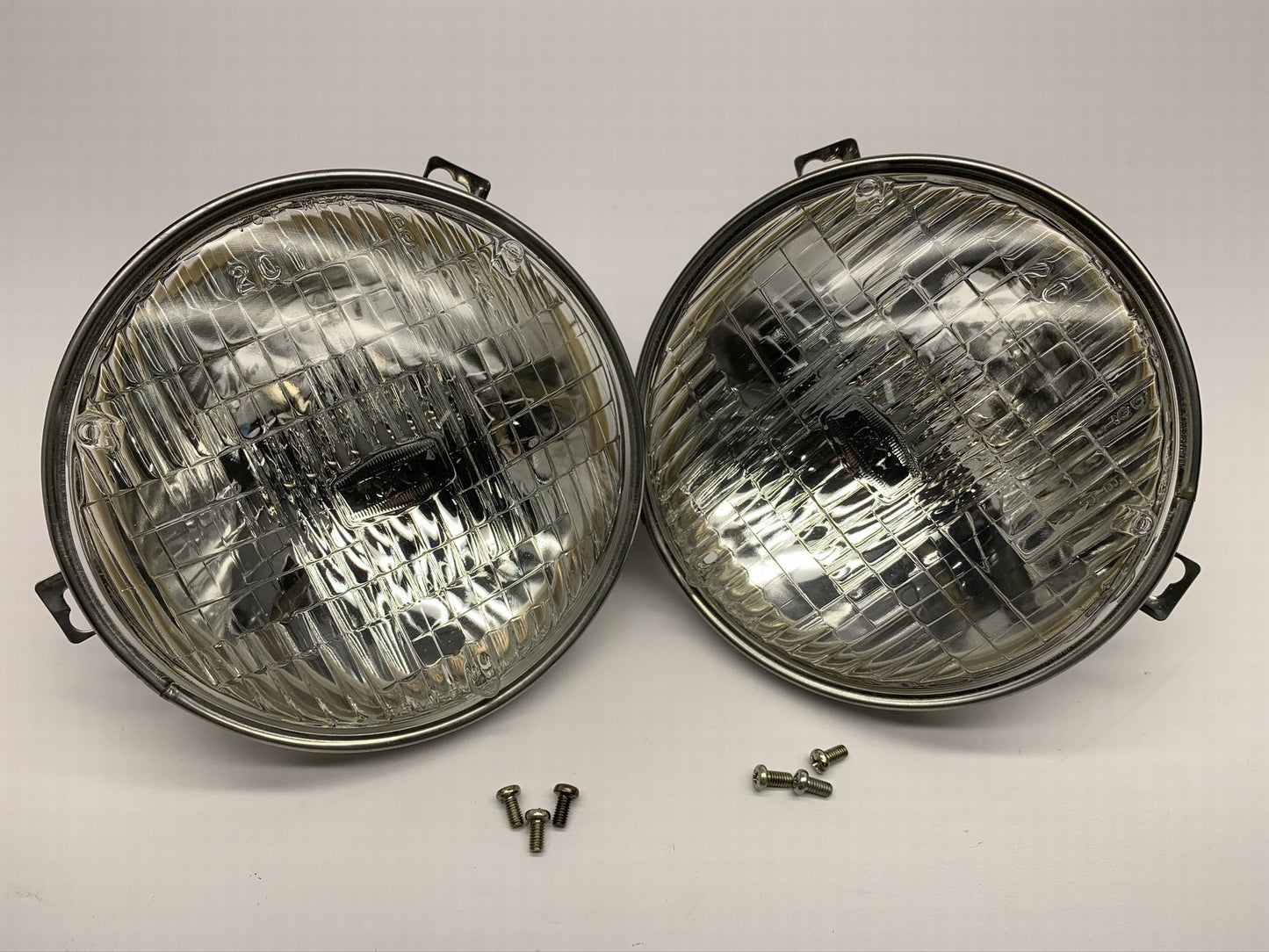 (2) NOS Genuine OEM IKI 5.75'' Headlight Head Lamps PAIR + Chrome Mounting Rings