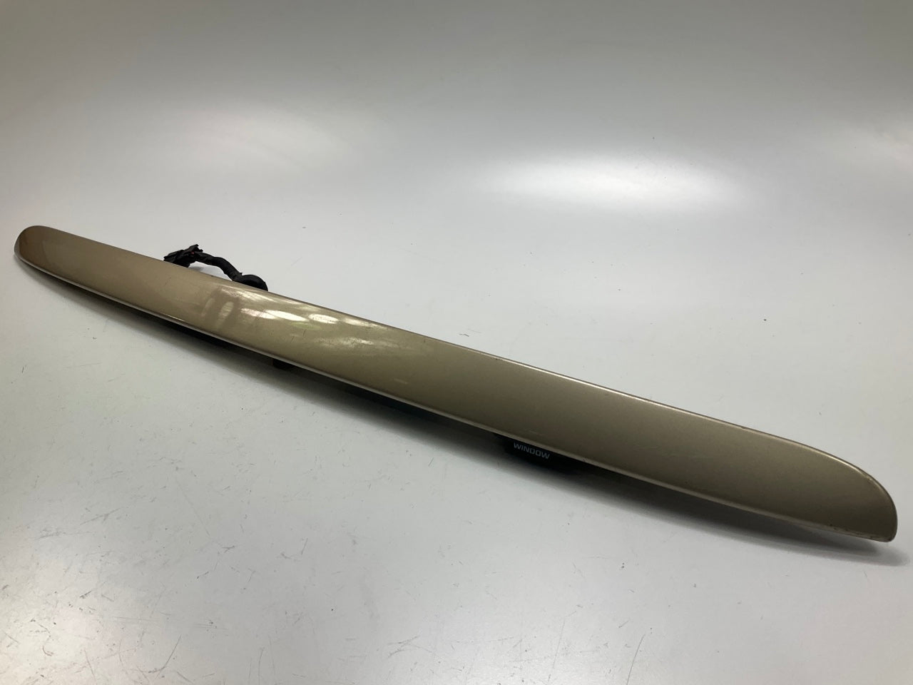 USED - 55155134AD Lift Gate License Plate Trim Champagne 99-04 Grand Cheroke