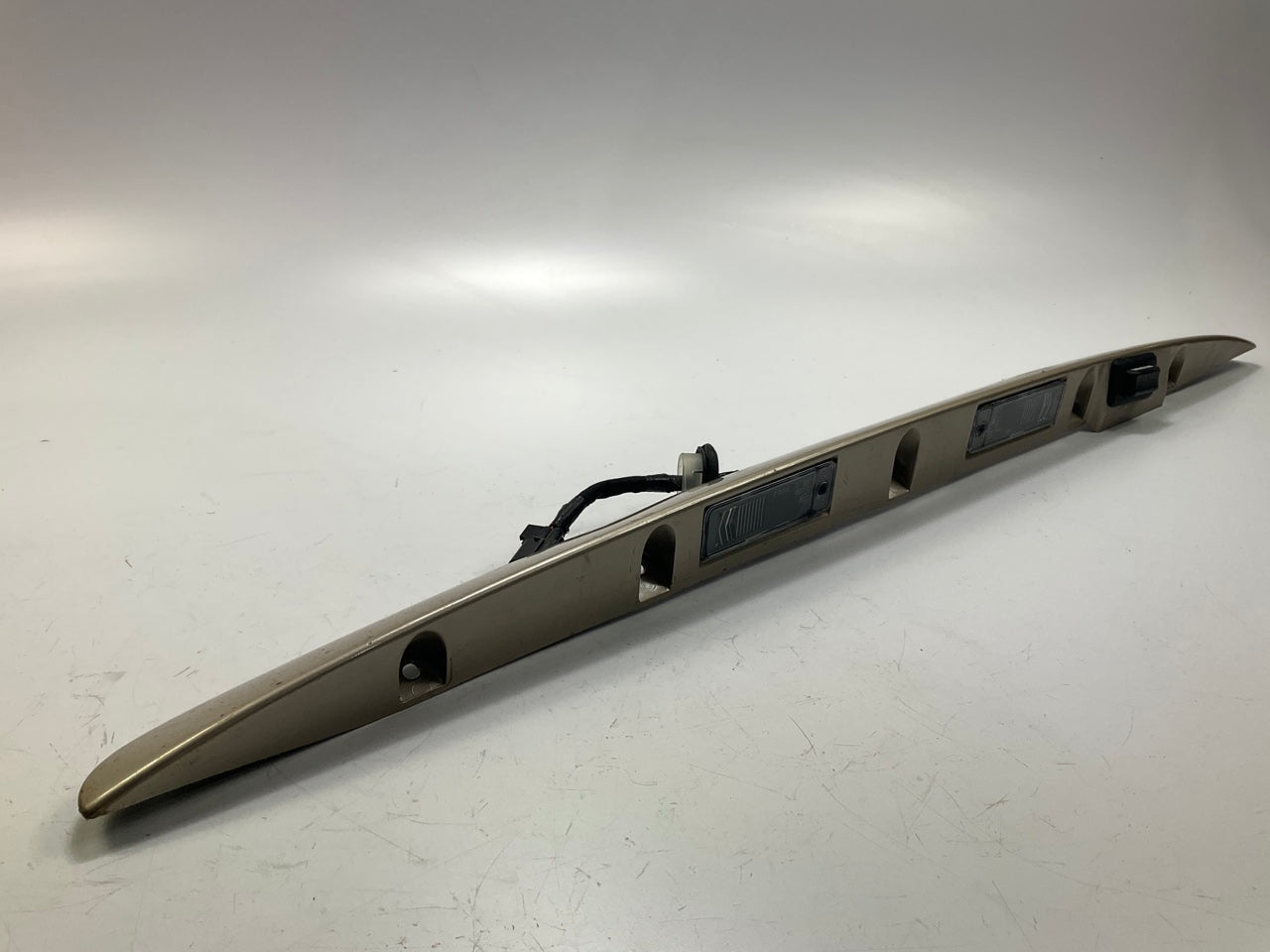 USED - 55155134AD Lift Gate License Plate Trim Champagne 99-04 Grand Cheroke