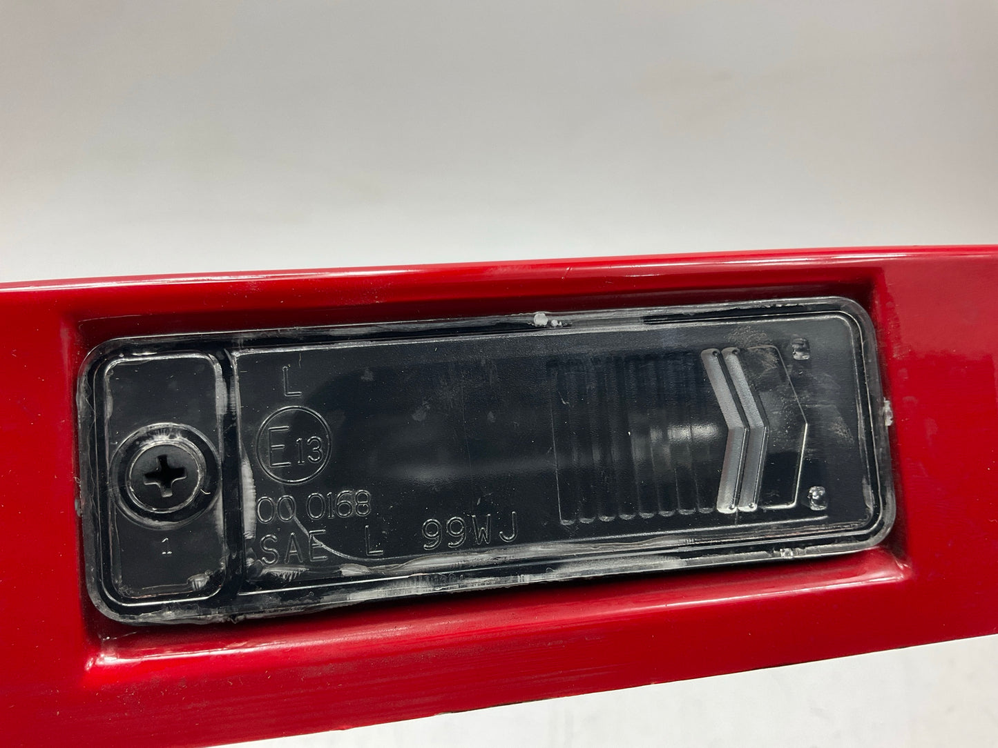 USED SCRATCHED - License Plate Lamp Light Trim Flame Red 99-04 Grand Cherokee